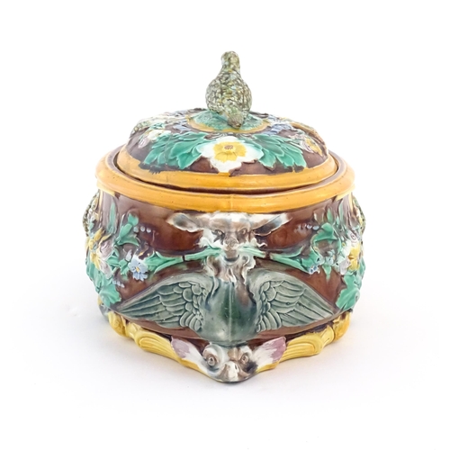 136 - A Victorian majolica game pie dish and cover, the body decorated in relief with birds, flowers and f... 