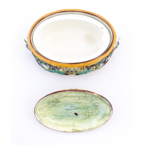 136 - A Victorian majolica game pie dish and cover, the body decorated in relief with birds, flowers and f... 