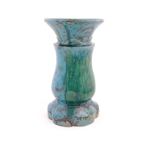 196 - A ceramic jardiniere stand of pedestal form with mottled blue / green glaze. Approx. 20 1/2