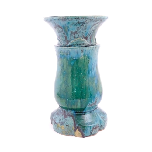 196 - A ceramic jardiniere stand of pedestal form with mottled blue / green glaze. Approx. 20 1/2