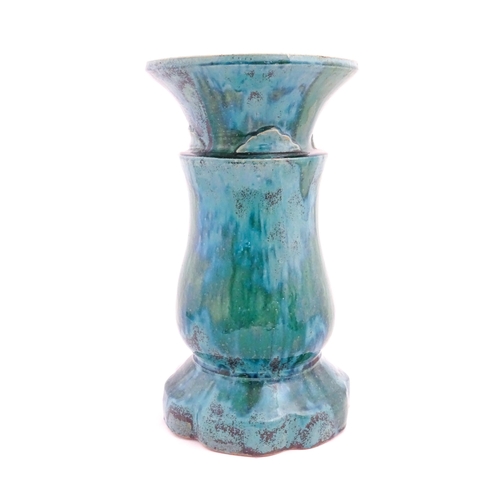 196 - A ceramic jardiniere stand of pedestal form with mottled blue / green glaze. Approx. 20 1/2