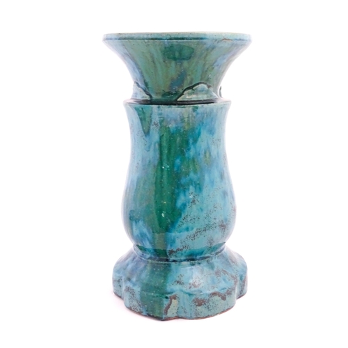 196 - A ceramic jardiniere stand of pedestal form with mottled blue / green glaze. Approx. 20 1/2