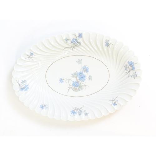 202 - A quantity of Haviland Limoges dinner wares in the Bergere pattern to include plates, serving dishes... 