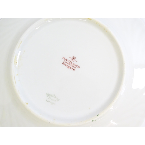 202 - A quantity of Haviland Limoges dinner wares in the Bergere pattern to include plates, serving dishes... 