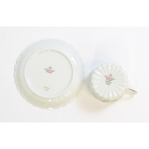 203 - A quantity of Haviland Limoges dinner wares in the Orsay pattern to include plates, serving dishes, ... 