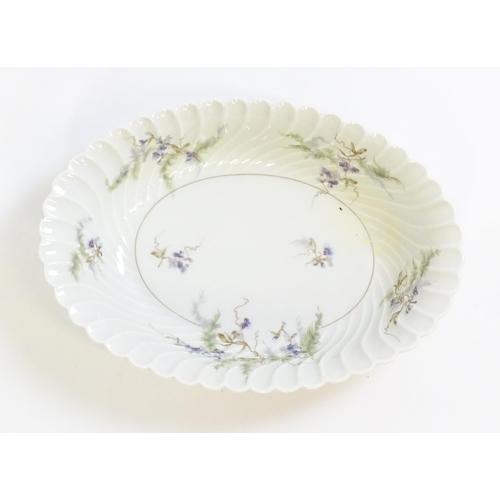 203 - A quantity of Haviland Limoges dinner wares in the Orsay pattern to include plates, serving dishes, ... 