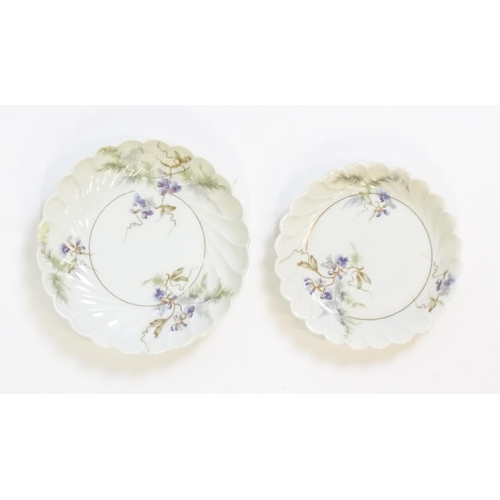 203 - A quantity of Haviland Limoges dinner wares in the Orsay pattern to include plates, serving dishes, ... 