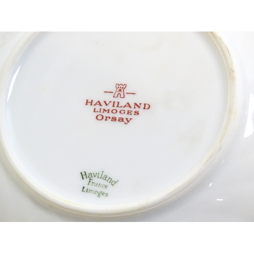 203 - A quantity of Haviland Limoges dinner wares in the Orsay pattern to include plates, serving dishes, ... 