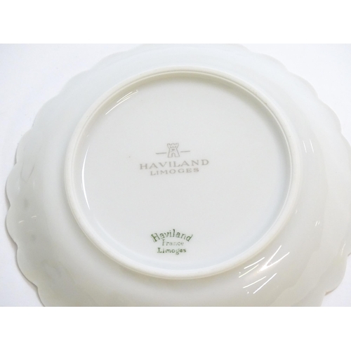 203 - A quantity of Haviland Limoges dinner wares in the Orsay pattern to include plates, serving dishes, ... 