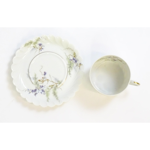 203 - A quantity of Haviland Limoges dinner wares in the Orsay pattern to include plates, serving dishes, ... 