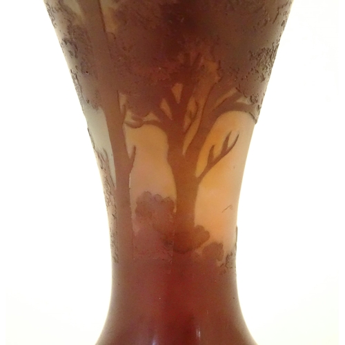 208 - A Galle glass vase with tree and landscape decoration. Approx 6 1/4