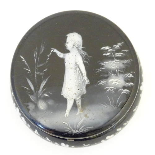 214 - A small black glass pot wit hinged lid having Mary Gregory detail to top. 2