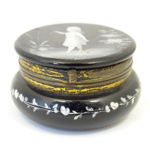 214 - A small black glass pot wit hinged lid having Mary Gregory detail to top. 2