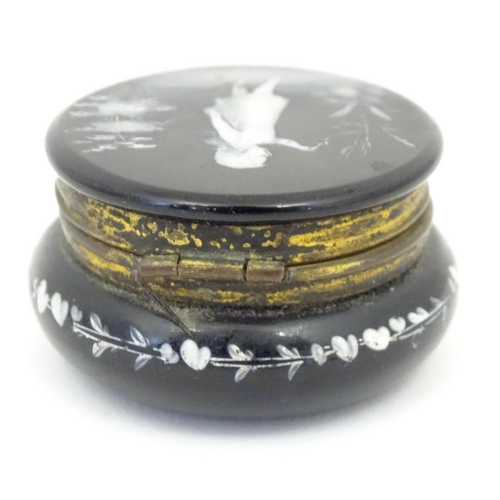 214 - A small black glass pot wit hinged lid having Mary Gregory detail to top. 2