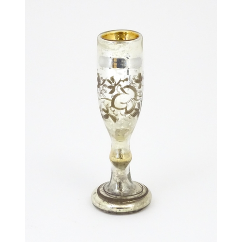 215 - A mercury glass pedestal glass / goblet with foliate detail approx 6