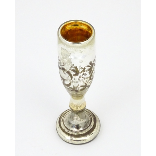 215 - A mercury glass pedestal glass / goblet with foliate detail approx 6