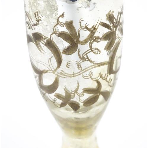 215 - A mercury glass pedestal glass / goblet with foliate detail approx 6