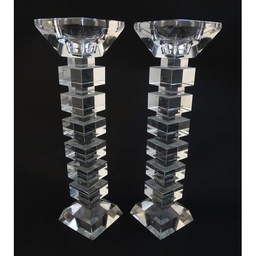 221 - A pair of glass candlesticks with geometric squared detail. Approx 8 1/2