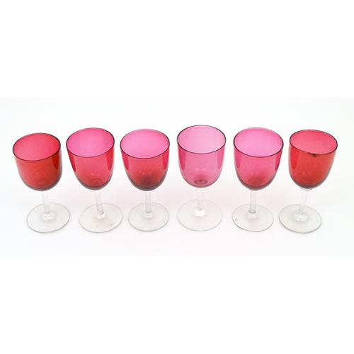 224 - Six assorted cranberry glass drinking glasses, with cranberry coloured bowls and clear glass stem an... 