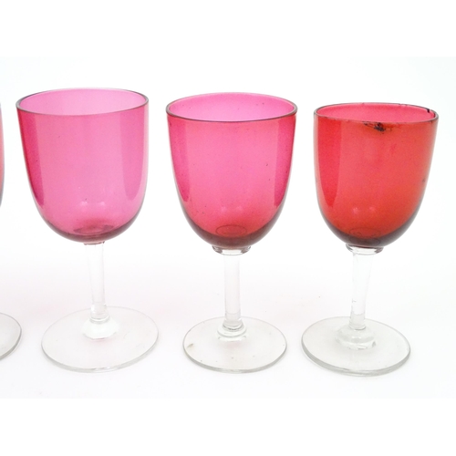 224 - Six assorted cranberry glass drinking glasses, with cranberry coloured bowls and clear glass stem an... 