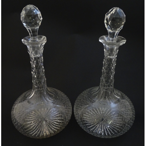 226 - Two 19thC cut glass decanters with star cut decoration. Approx 11