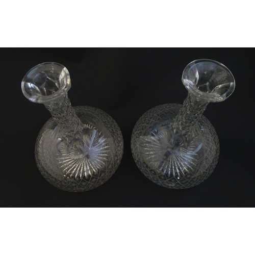 226 - Two 19thC cut glass decanters with star cut decoration. Approx 11