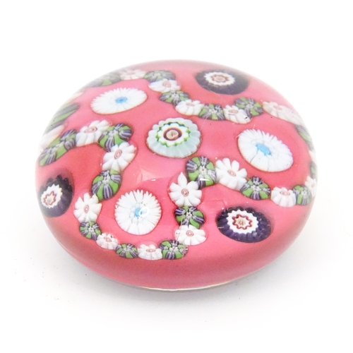 233 - A 19thC  trefoil garland millefiori paperweight, the pink ground with loops of trefoil garland and w... 