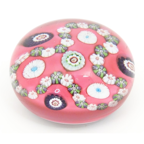 233 - A 19thC  trefoil garland millefiori paperweight, the pink ground with loops of trefoil garland and w... 