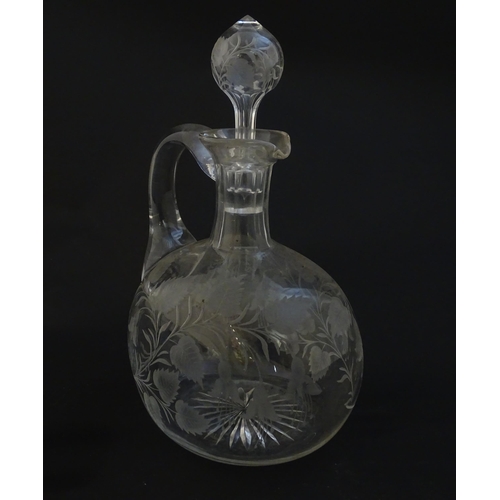 236 - A 19thC etched glass water jug / carafe and stopper with floral fuchsia detail. Approx. 8