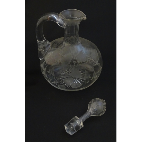 236 - A 19thC etched glass water jug / carafe and stopper with floral fuchsia detail. Approx. 8