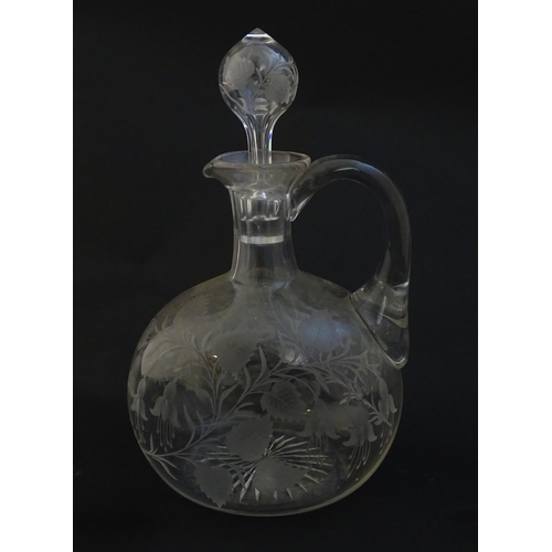 236 - A 19thC etched glass water jug / carafe and stopper with floral fuchsia detail. Approx. 8