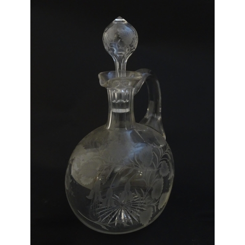 236 - A 19thC etched glass water jug / carafe and stopper with floral fuchsia detail. Approx. 8