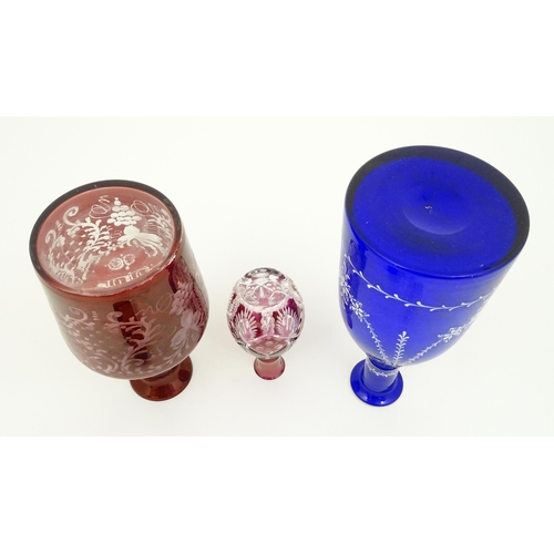 250 - Three assorted glass decanters to include ruby, blue and cranberry coloured examples. The largest ap... 