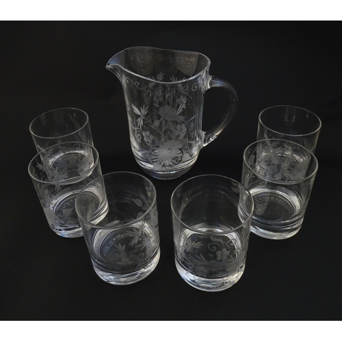 251 - A glass water jug and 6 glasses with engraved floral detail. The Jug approx 7 1/4