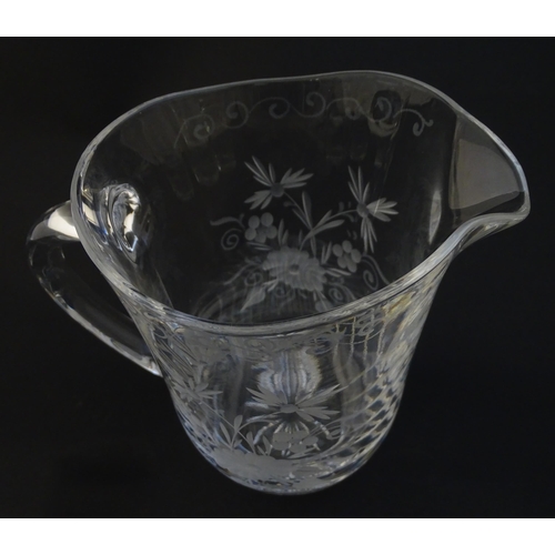 251 - A glass water jug and 6 glasses with engraved floral detail. The Jug approx 7 1/4