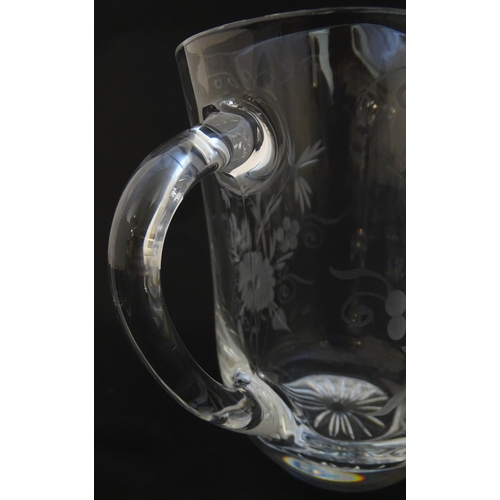 251 - A glass water jug and 6 glasses with engraved floral detail. The Jug approx 7 1/4