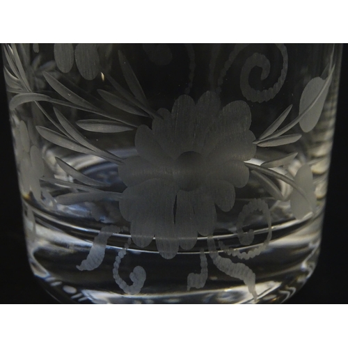 251 - A glass water jug and 6 glasses with engraved floral detail. The Jug approx 7 1/4