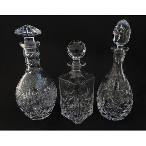 252 - Three  various cut crystal /  glass decanters. The tallest approx 12 1/4