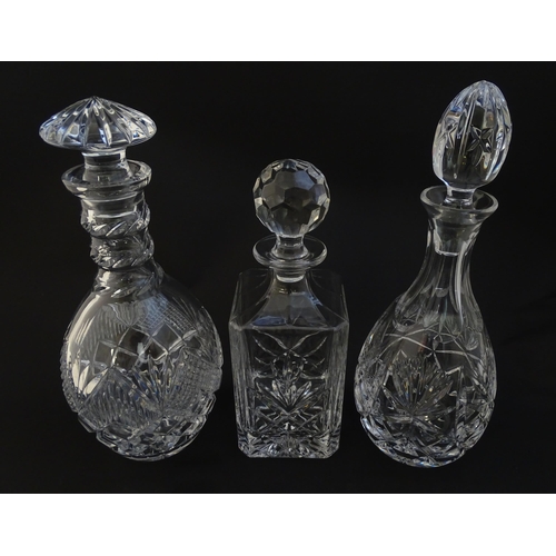 252 - Three  various cut crystal /  glass decanters. The tallest approx 12 1/4