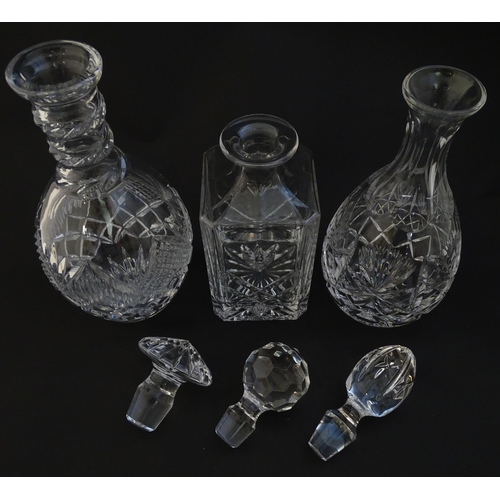 252 - Three  various cut crystal /  glass decanters. The tallest approx 12 1/4