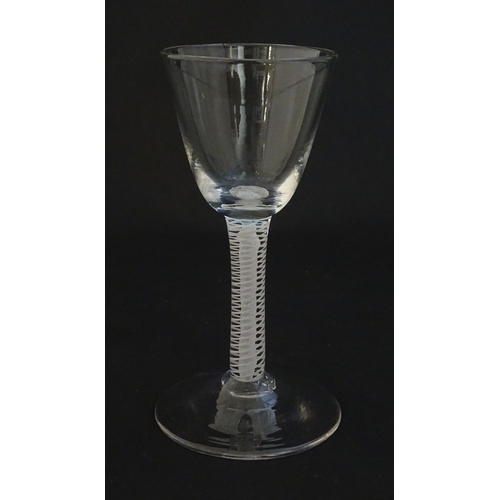 252A - A 19thC pedestal drinking glass with twist detail to stem. Approx 4 1/4