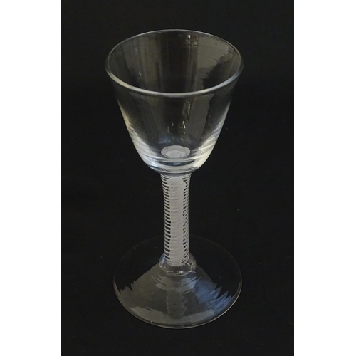 252A - A 19thC pedestal drinking glass with twist detail to stem. Approx 4 1/4