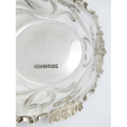 264 - A silver bonbon dish of oval form with embossed decoration, hallmarked Birmingham 2002 with Elizabet... 