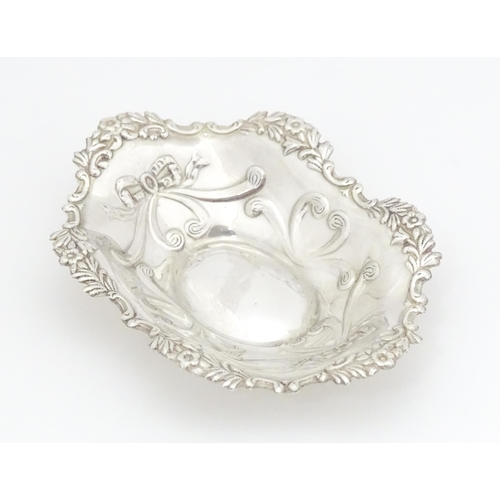 264 - A silver bonbon dish of oval form with embossed decoration, hallmarked Birmingham 2002 with Elizabet... 