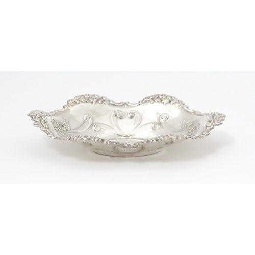 264 - A silver bonbon dish of oval form with embossed decoration, hallmarked Birmingham 2002 with Elizabet... 