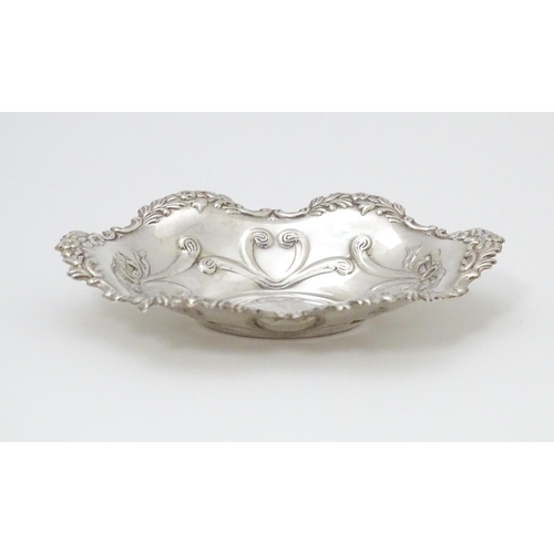 264 - A silver bonbon dish of oval form with embossed decoration, hallmarked Birmingham 2002 with Elizabet... 