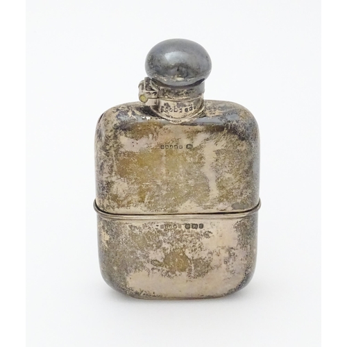 271 - A Victorian silver hip flask. With engraved squirrel armorial. Hallmarked Sheffield 1898 maker G & J... 