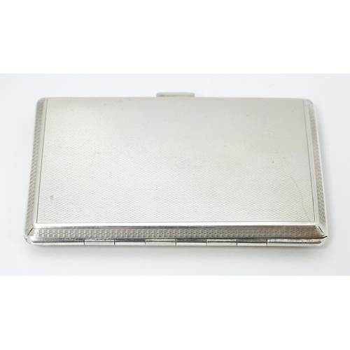 275 - An Art Deco silver cigarette case with enamel Spaniel dog decoration, engine turned detail and gilde... 