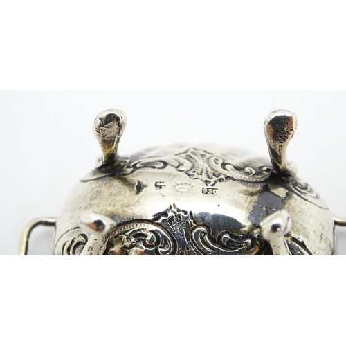 279 - A pair of Continental .930 silver salts with  engraved decoration and twin handles raised on four fe... 