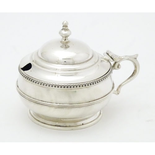 285 - A silver mustard pot with blue glass liner hallmarked Birmingham 1919 maker Collingwood & Sons Ltd. ... 